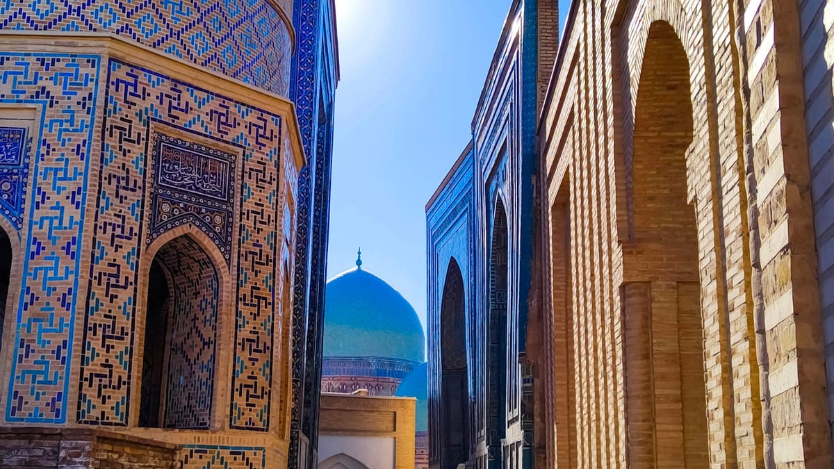 Tiled passageway and a blue dome in Samarkand